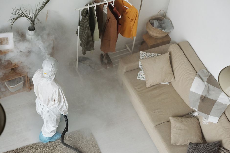 Technician fogging a living room during a treatment visit